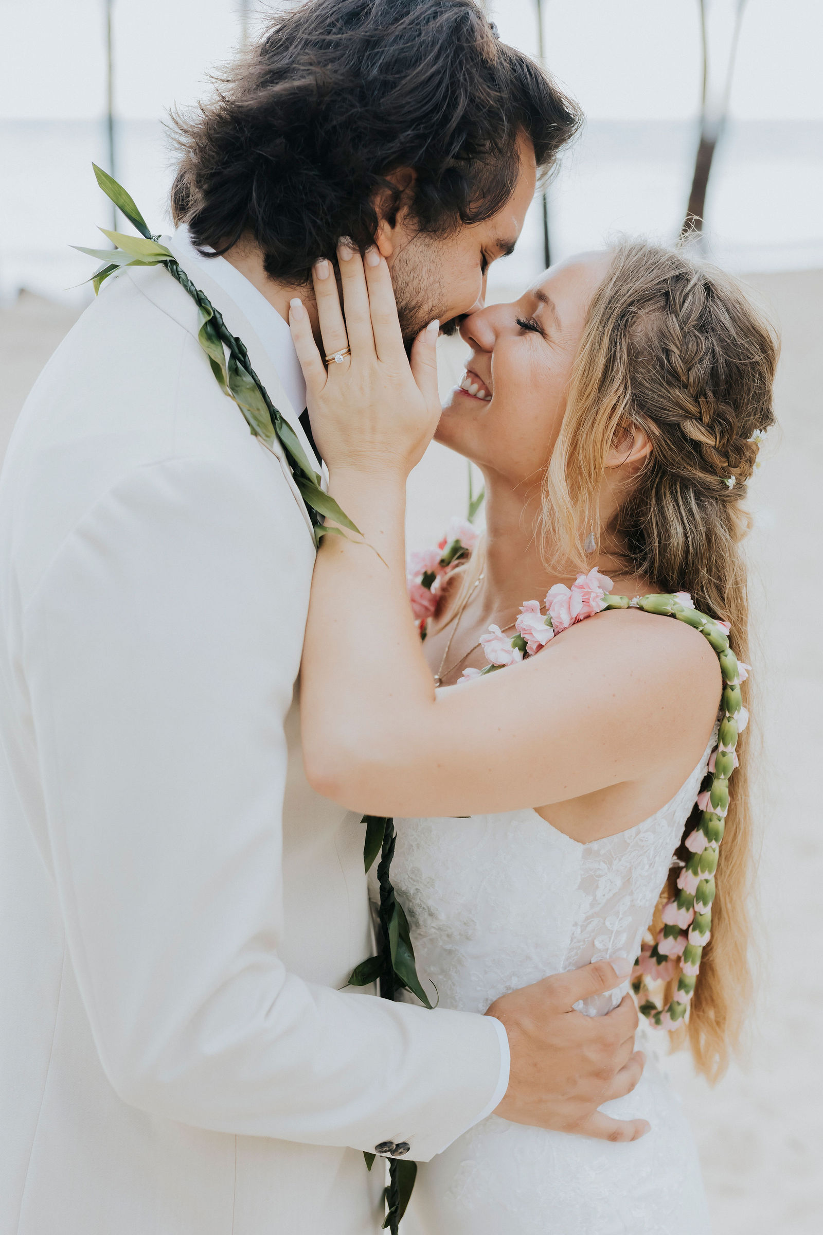 AynMarie and Vicente kissing after their beachfront ceremony
