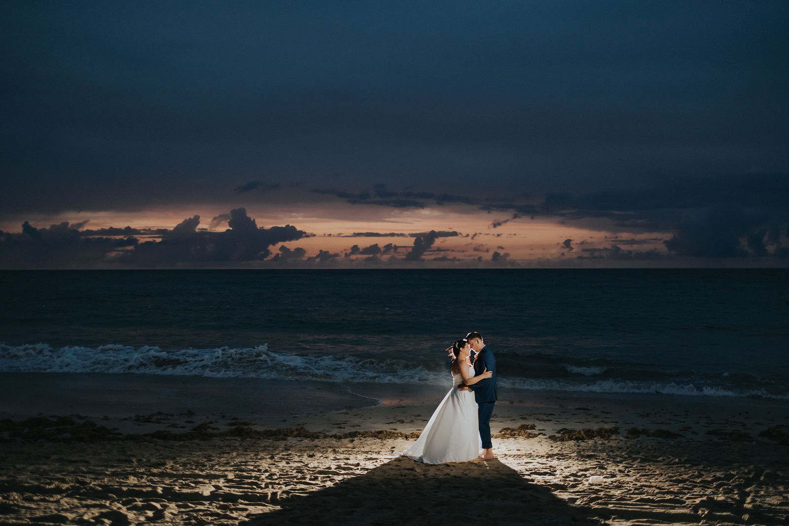Kati and David silhouetted against a Caribbean sunset